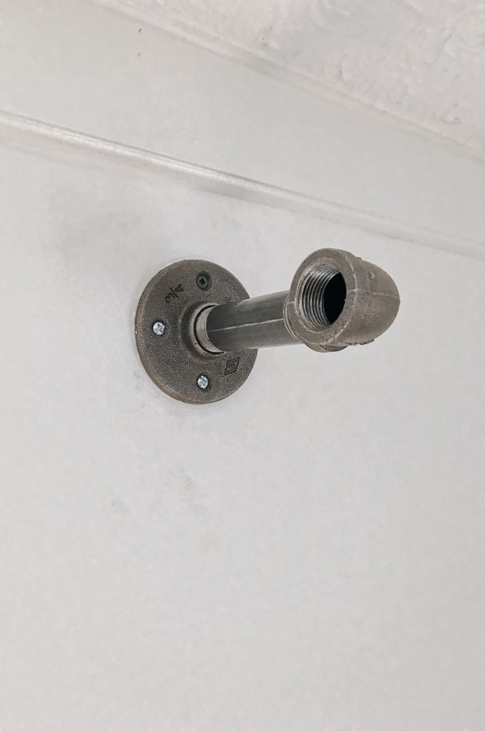 curtain rod bracket mounted to the wall